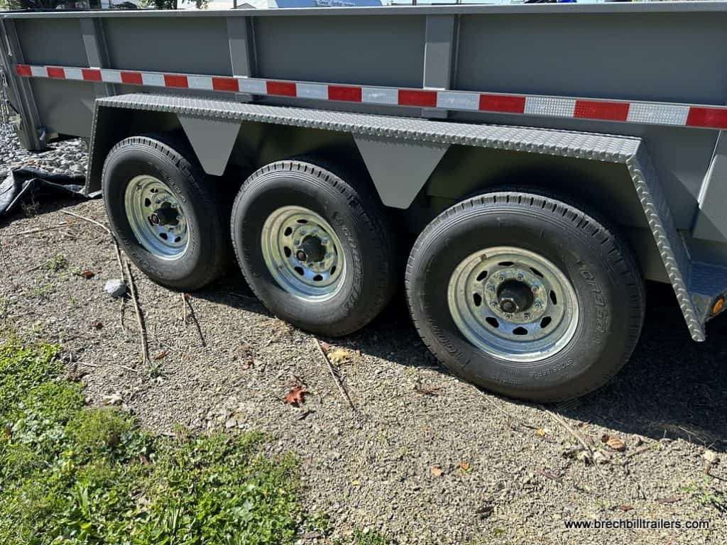 Wheels on a gray Bwise 21K DLP Heavy Duty Dump Trailer