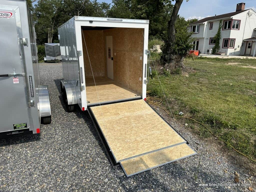 A new Bravo Scout 7K Enclosed Cargo Trailer with the ramp down