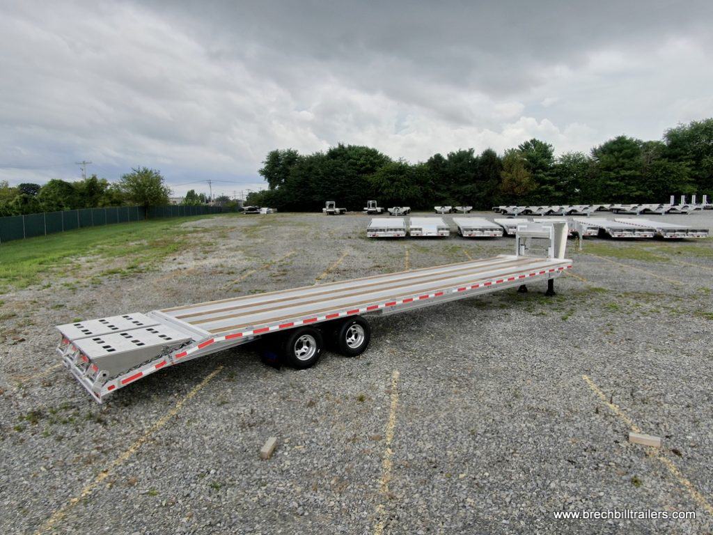 EBY 26K Deck-Over Gooseneck Equipment Trailer in the parking lot for sale.