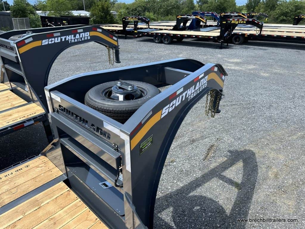 A gooseneck with the spare tire mounted on top of it.