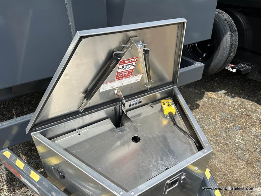 Open front storage box on the Southland 15K Tandem Axle High Side Dump Trailer with hydraulic control system.