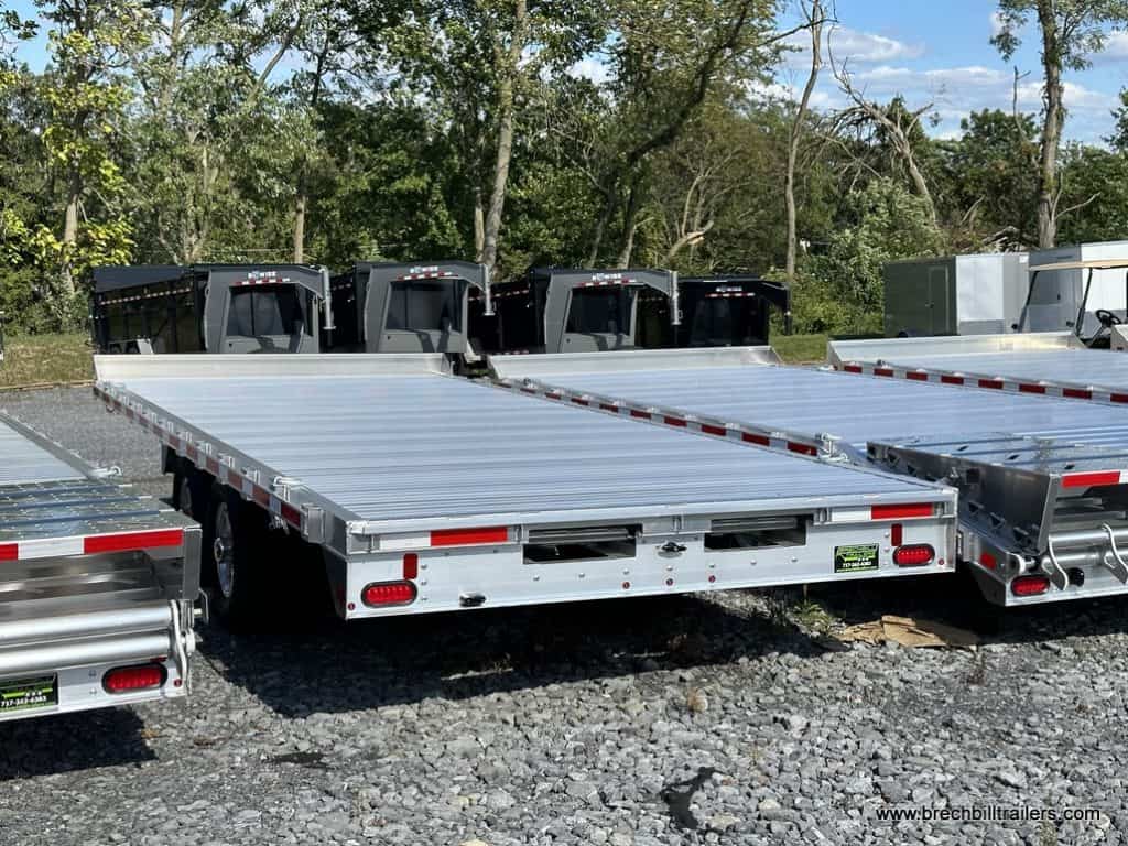 A EBY 14K Deck-Over Equipment Trailer parked in the lot.