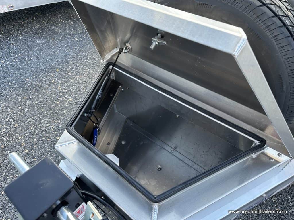 The open toolbox on the front of the trailer.