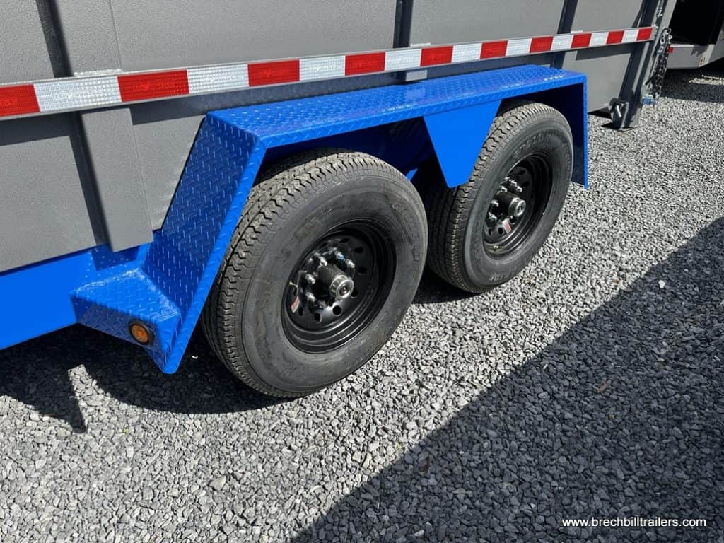 Close up of the black wheels on the heavy duty dump trailer.