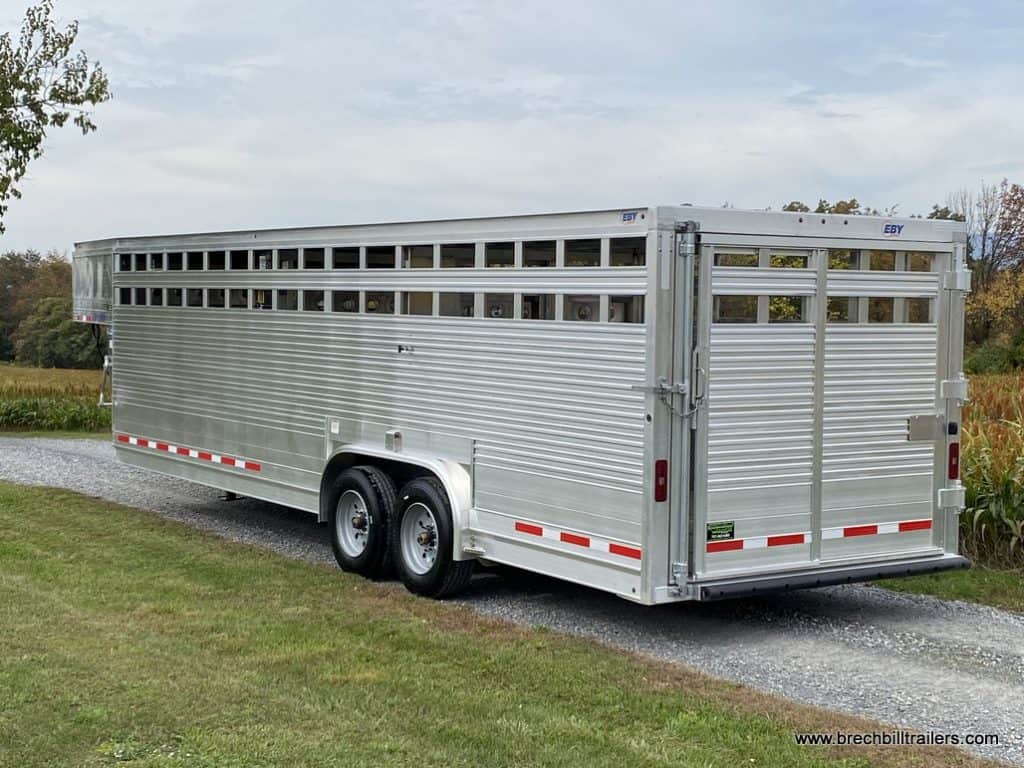 Full view of the EBY 19K Ruff Neck Livestock Trailer on a road.