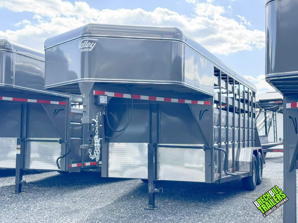 A Valley 12k Gooseneck Stock Trailer parked and ready for pickup at Brechbill Trailers.
