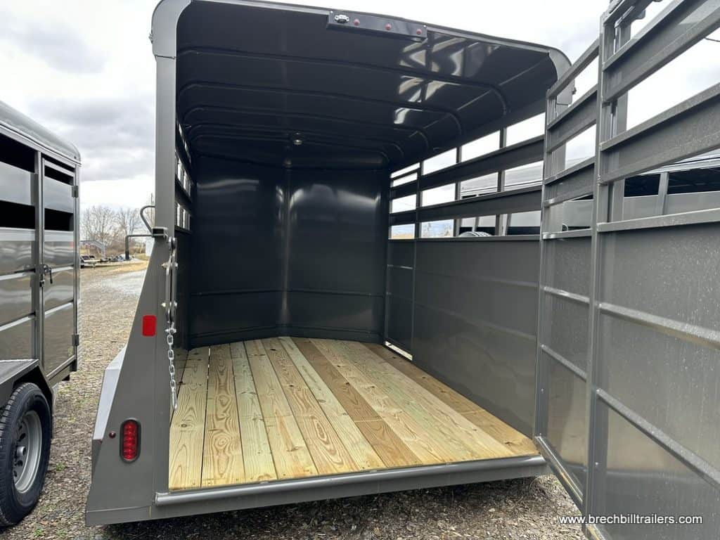 A Valley 7x12 High Side Stock Trailer with gate open to preview the inside.