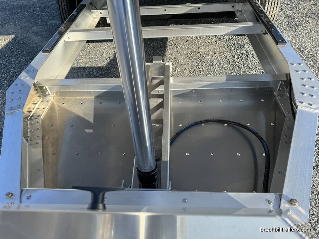 Cylinder raised to put trailer in dump position.