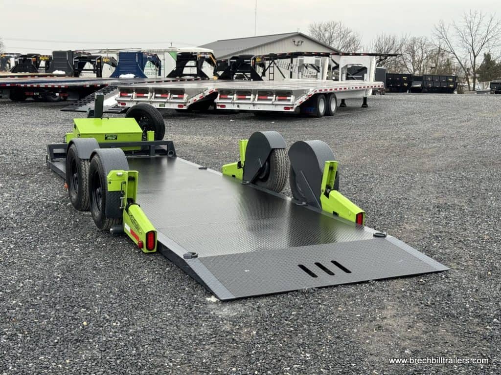 FlatTrak Flat Deck Scissor Lift lowered to the ground for loading and unloading equipment.