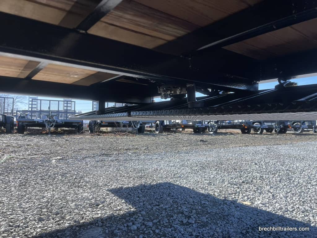 Under the Bwise 15.4K Hydraulic Tilt-Deck Trailer while ramps are folded under the deck.
