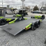 FlatTrak 7x18 Lay Flat 14K Equipment Hauler Trailer parked in the lot.