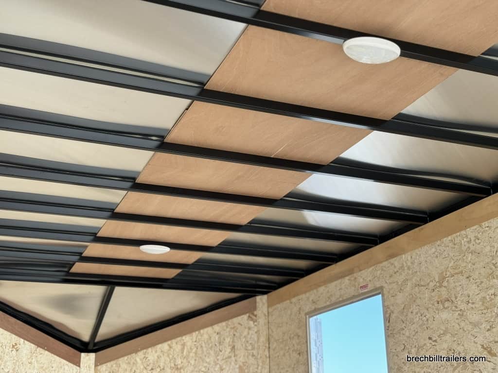 Interior lights on the ceiling in the enclosed trailer.