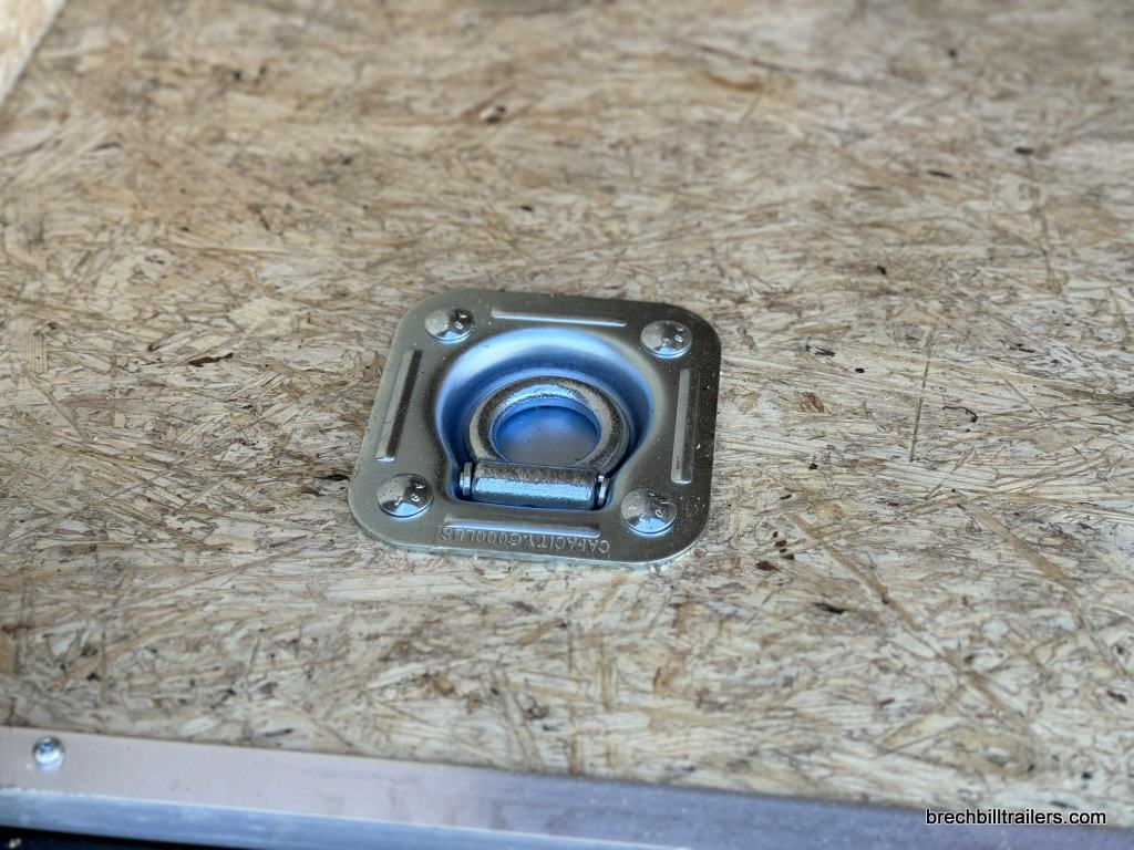 A d ring on the Bravo Scout 7K Enclosed Cargo Box Trailer floor