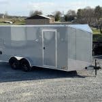 A detached Bravo Scout 7K Enclosed Cargo Box Trailer ready for pickup.