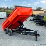 14ft long dump trailer in position to dump a load.