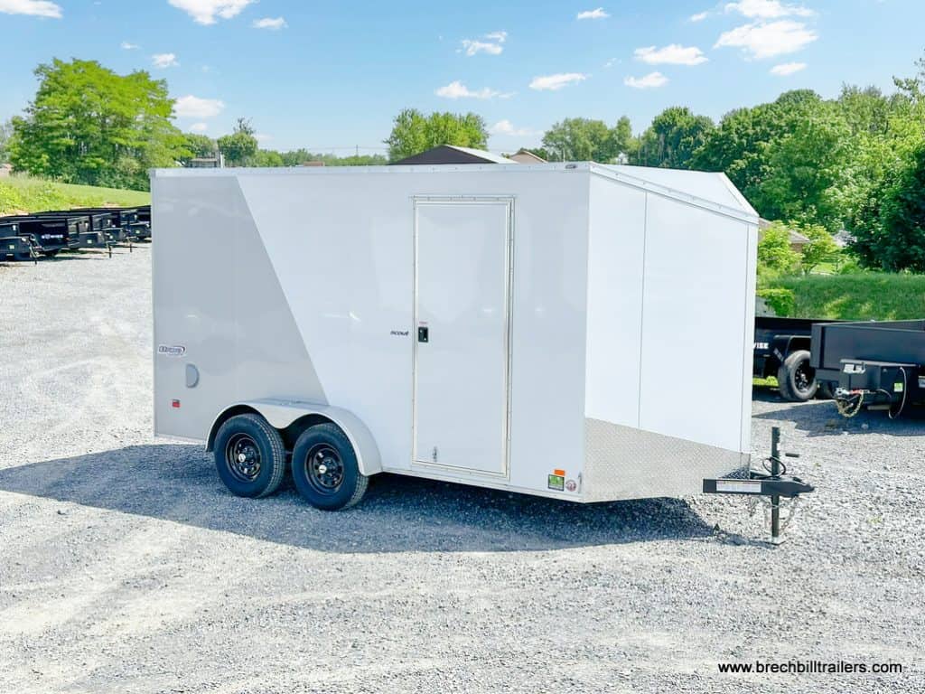 Side view of the Bravo 7K Scout Enclosed Cargo Trailer parked in the lot.