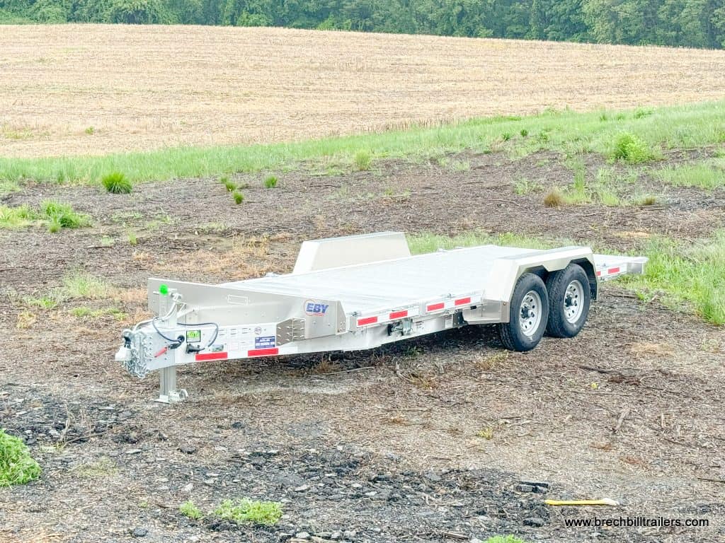 A EBY Aluminum Heavy Duty Gravity Tilt Trailer 14K parked alone in the lot.