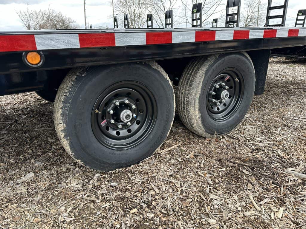 Black wheels on a 24ft long Bwise 15.4K Hydraulic Tilt-Deck Trailer