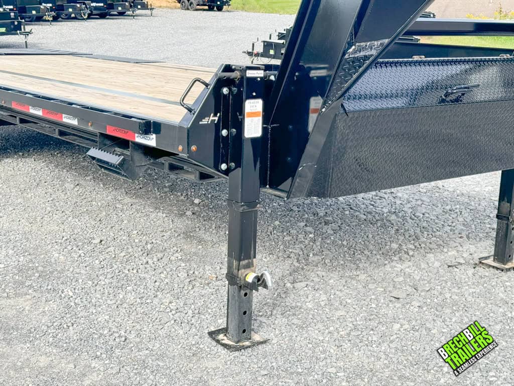 Dual jacks holding up a parked Horizon 24ft Flatdeck Gooseneck Trailer