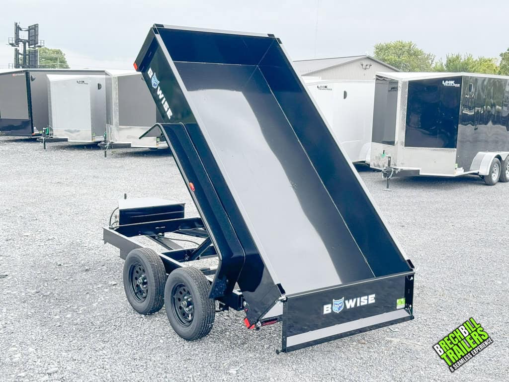 A Bwise 5x10 Small Dump Trailer in the dumping position.