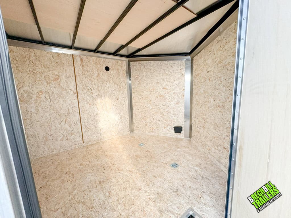 Inside view of a new Look Enclosed V-nose Cargo Trailer with wood floors and walls.