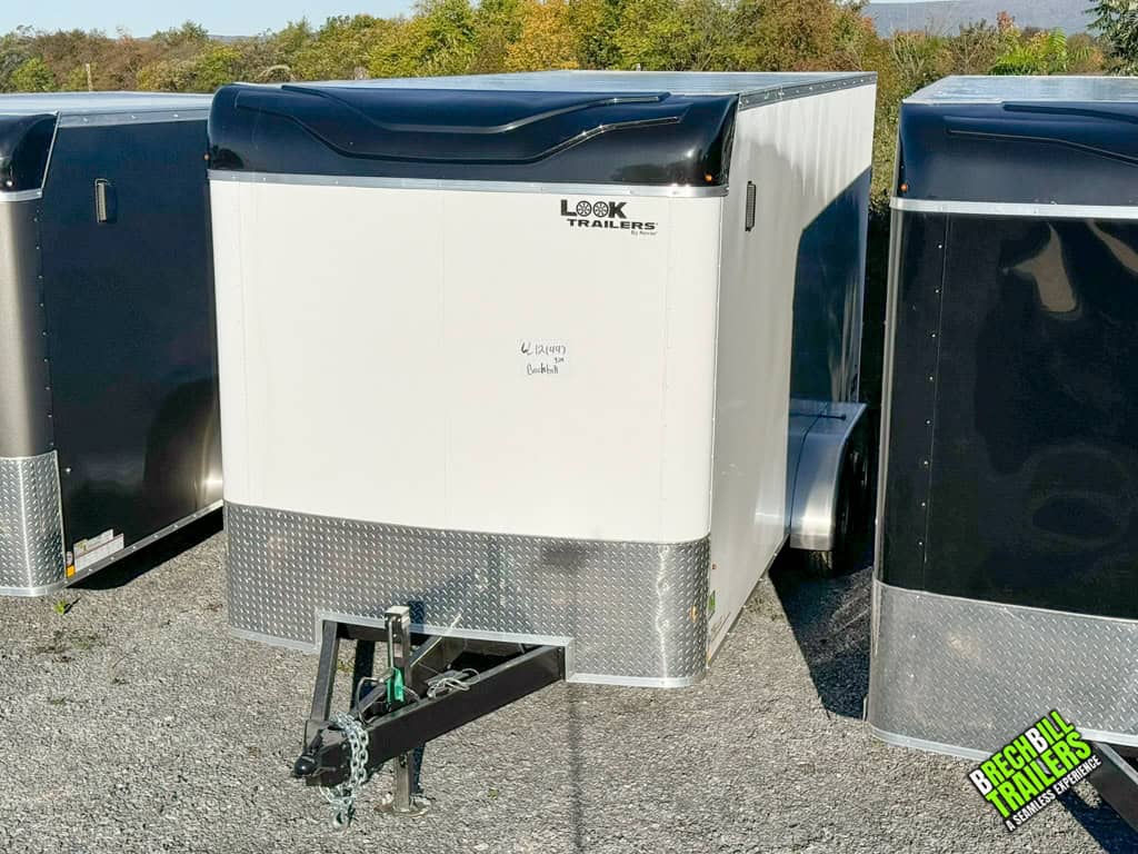 A new white 16ft long Look XLT Enclosed V-nose Cargo Trailer