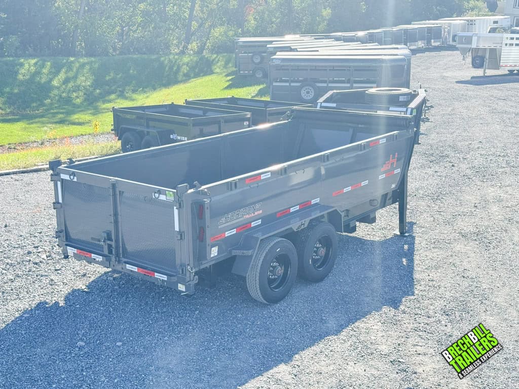 A parked Horizon HD Gooseneck Dump Trailer for sale at Brechbill Trailers on a sunny day.