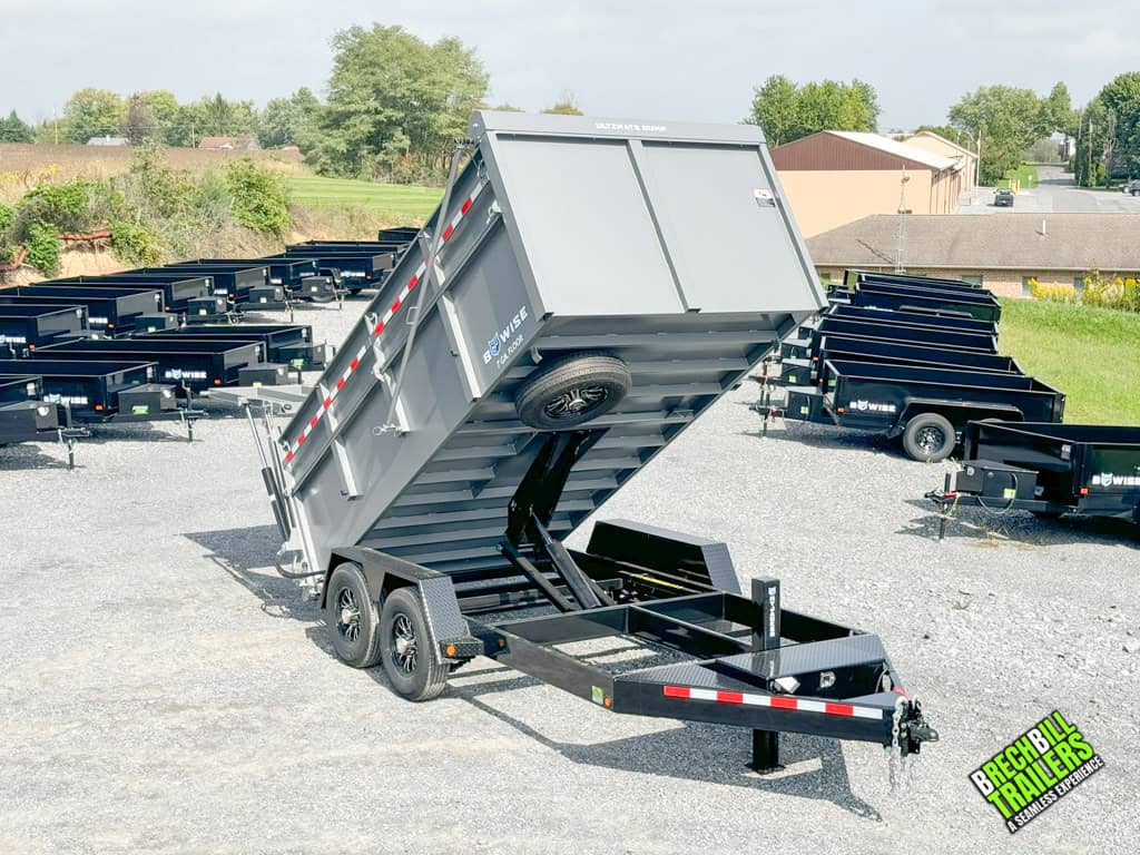Bwise DU 15.4K Ultimate Dump Trailer int he dump position with spare tire in sight.