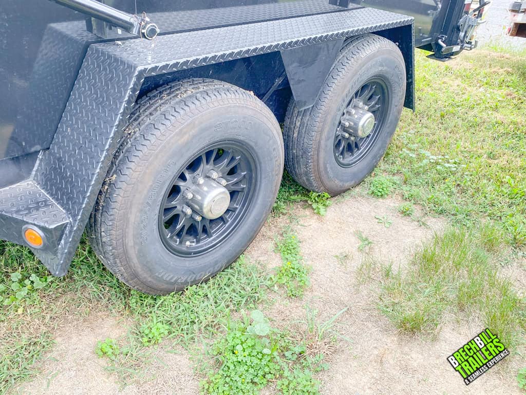 Left side wheels on a Used Bwise DU Ultimate Dump Trailer