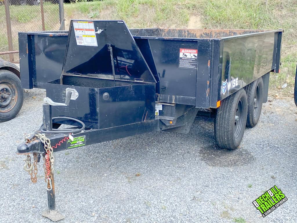 A Used Bwise 7K Deck Over Dump Trailer parked on display.