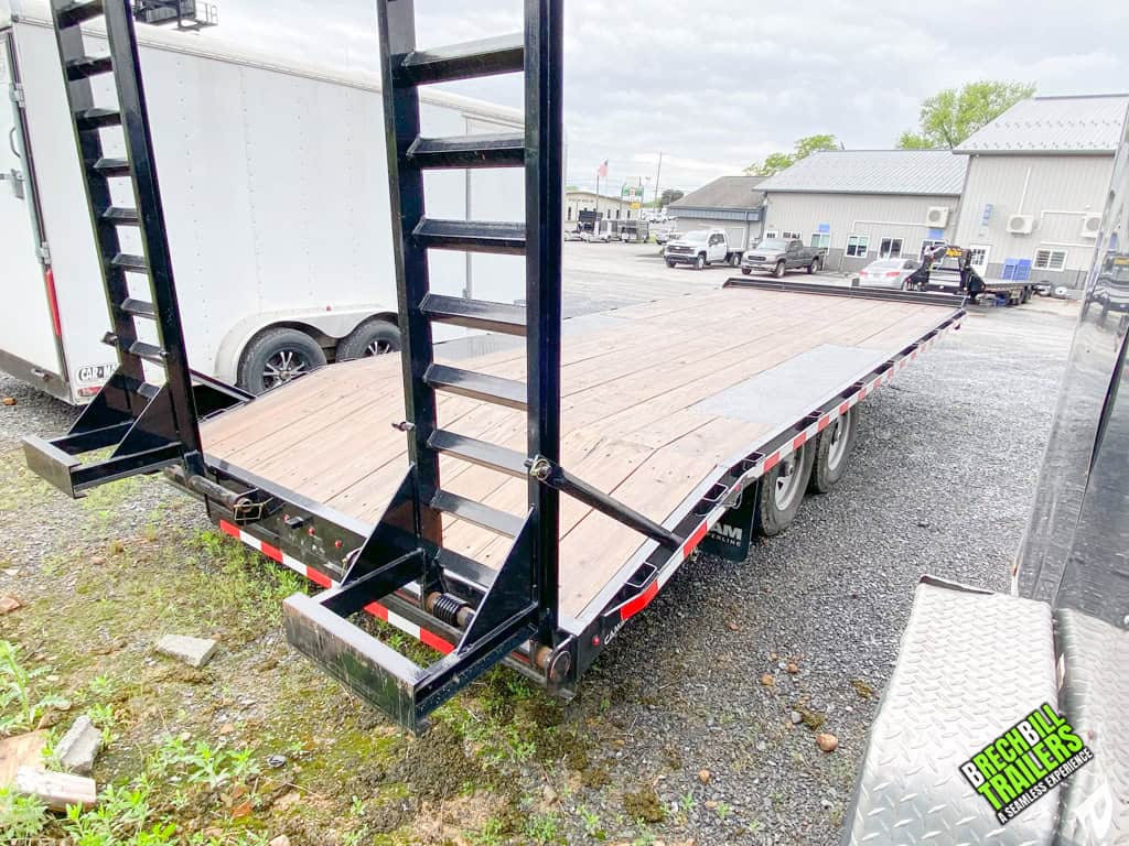 The ramps on a Used CAM 11K Deck Over Equipment Trailer