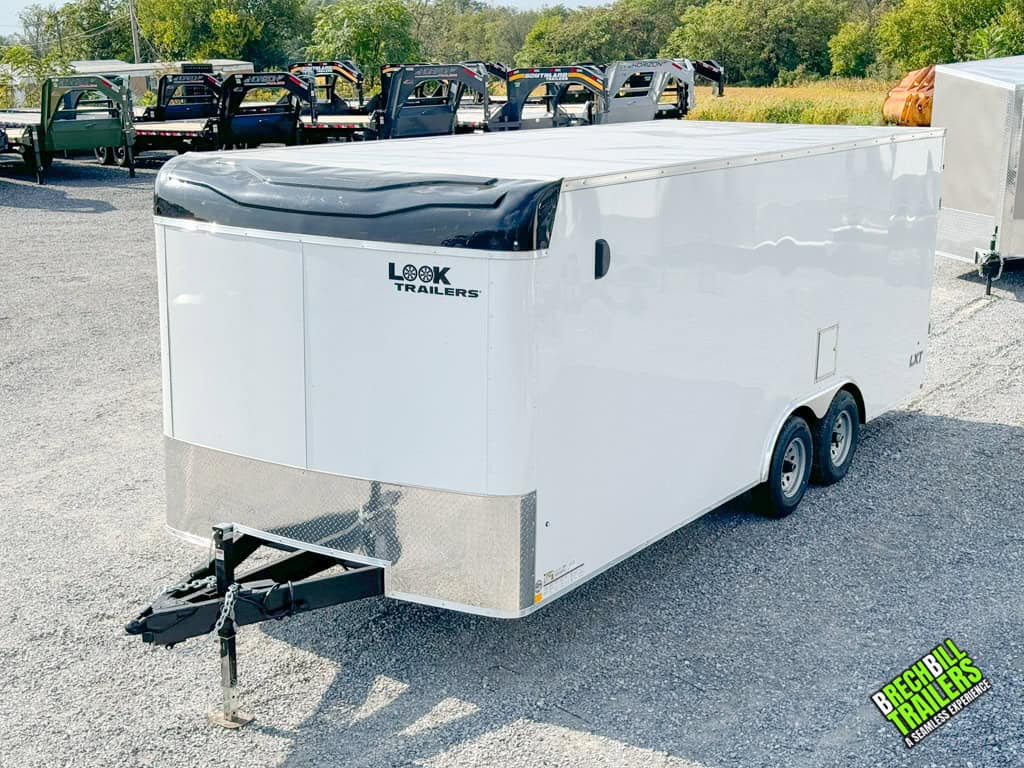 A brand new, white, Look Flat Top XLT Bullnose Enclosed Trailer parked in the yard.