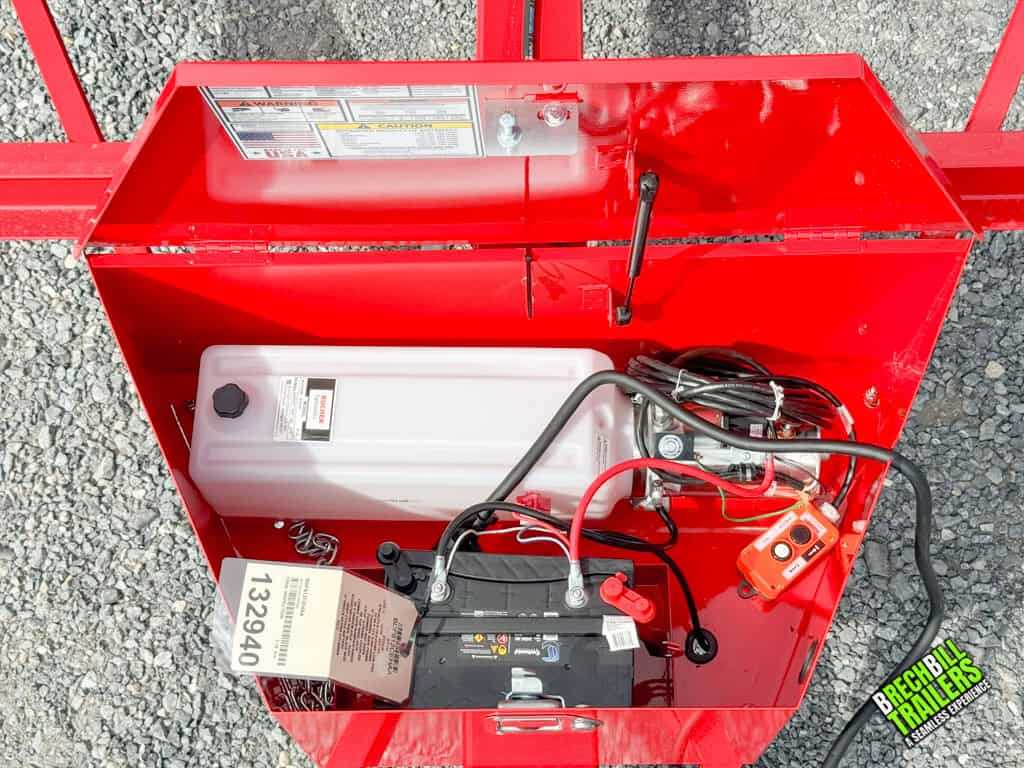 The motor and battery on the Bwise LP LE 10K Low Pro Dump Trailer