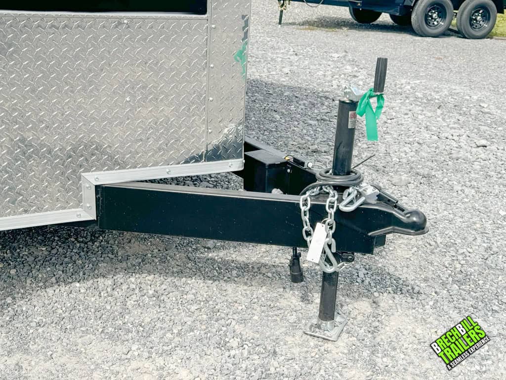 Trailer coupler and the jack down on a parked cargo trailer.