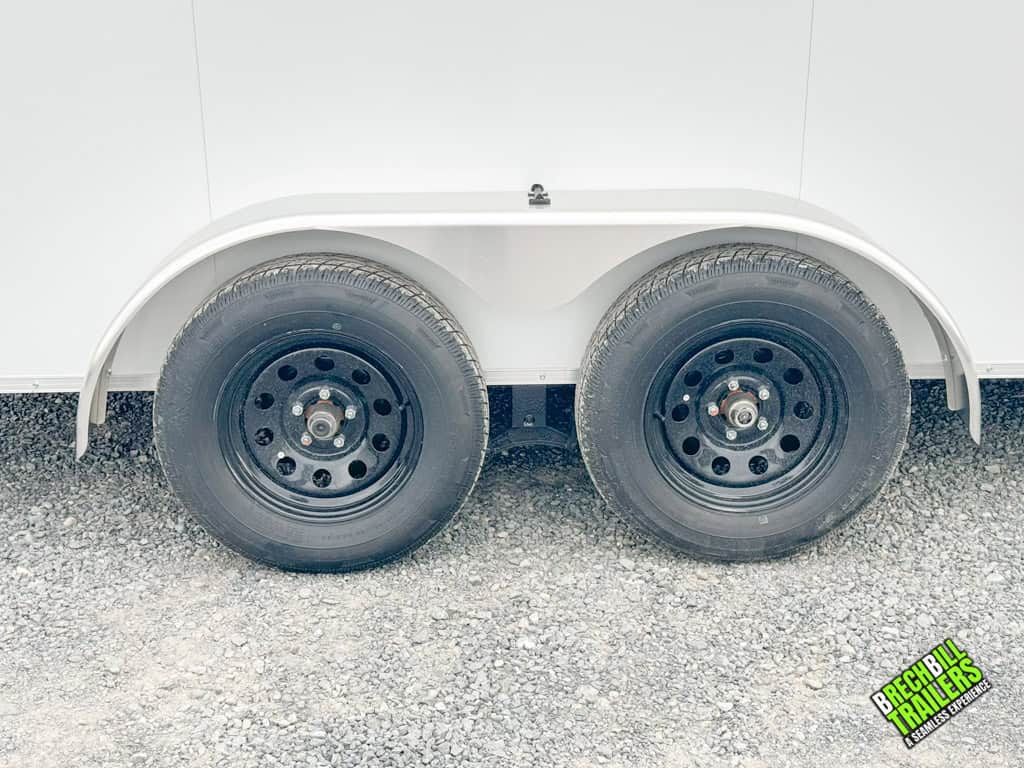 Black wheels on a white cargo trailer.