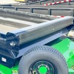 Close u p of tarp on a black and lime green Horizon dump trailer