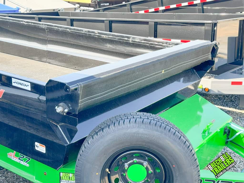 Close u p of tarp on a black and lime green Horizon dump trailer