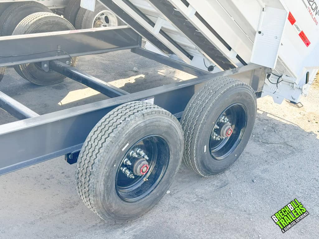 Axles on a white Horizon HD gooseneck dump trailer