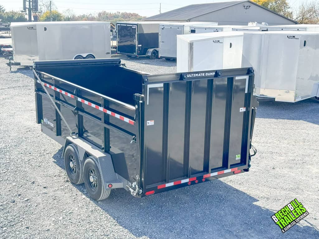 Brand new Bwise DU Ultimate Dump Trailer 7x16 parked at the dealership