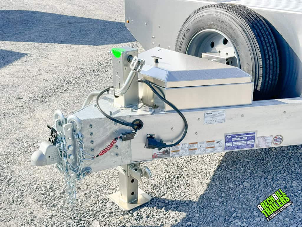 Trailer coupler, jack, toolbox, and spare wheel on an EBY Deck-Over 16K Equipment Trailer