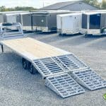 Cloudy gray colors Horizon 26ft Deck Over Gooseneck Trailer with ramps down on display.