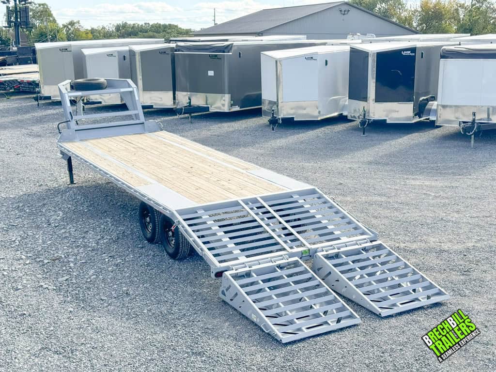 Cloudy gray colors Horizon 26ft Deck Over Gooseneck Trailer with ramps down on display.
