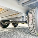 Bottom view of the Horizon 26ft Deck Over Gooseneck Trailer shows the axles and suspension.