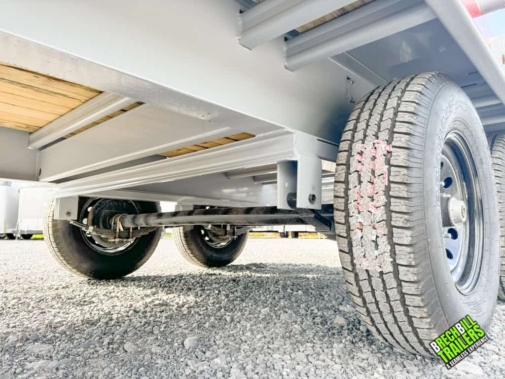 Bottom view of the Horizon 26ft Deck Over Gooseneck Trailer shows the axles and suspension.
