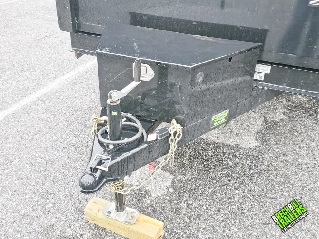 Jack holding up the Used Bwise R Series 7K Dump Trailer on display at Brechbill Trailers.