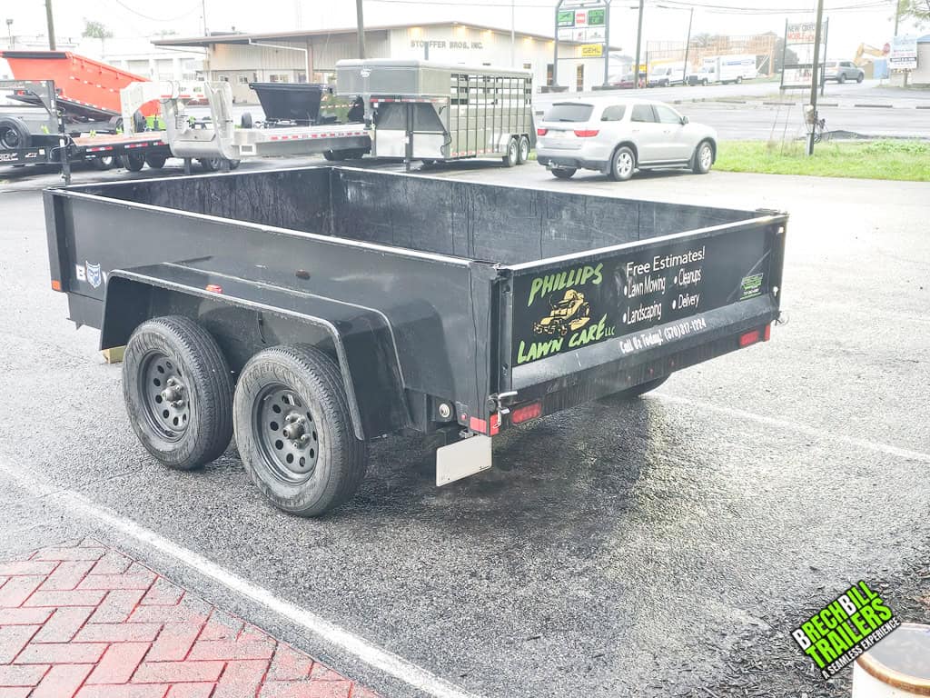 Angled view of the Used Bwise R Series 7K Dump Trailer for sale.