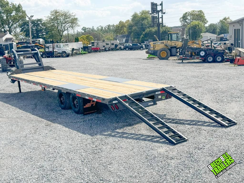 A gray Horizon 30ft Deck Over Gooseneck Trailer with the ramps down.