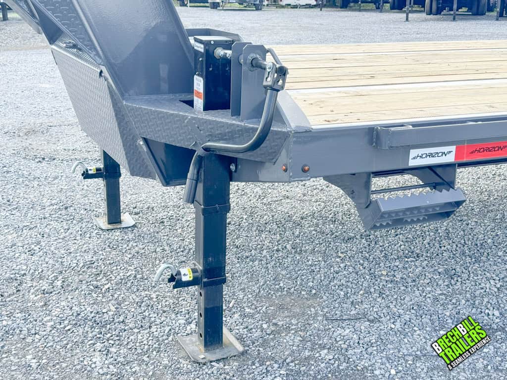 Dual jacks holding up the Horizon 30ft Deck Over Gooseneck Trailer.