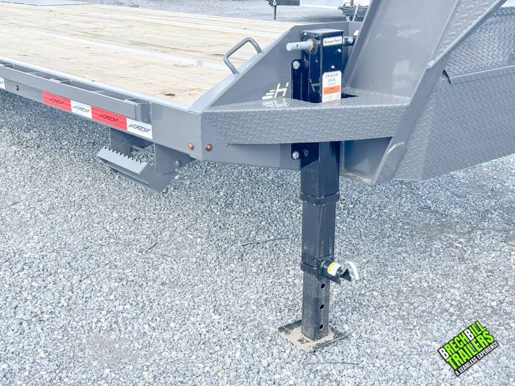 Black jack holding a parked Horizon 30ft Deck Over Gooseneck Trailer.