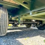 The axle, wheel, frame, and leaf springs on a GN-FHZSS30 deck over trailer